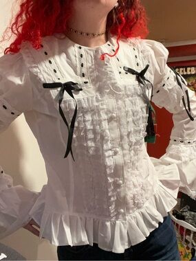 Victorian-Inspired White Ruffle Button-Up Blouse with Black Ribbon Detail